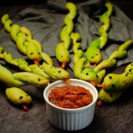 snake breadsticks served with a pot of red chilli sauce for dipping