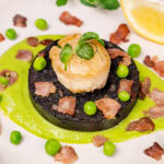 scallops with pea puree served on black pudding with crispy bacon
