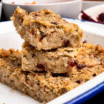 Sage and Onion Stuffing cut into squares stacked up in a oven proof dish