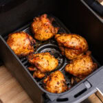 Cooked Skinless and Boneless Chicken Thighs in the Air Fryer basket