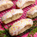 Iced Buns with Sprinkles on a wire rack