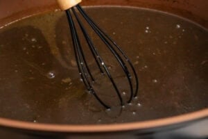 Whisking the beef gravy in a pot