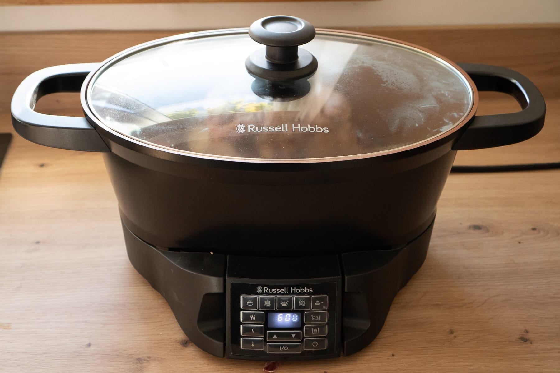 A Russell hobs slow cooker with a beef shin cooking inside with the lid placed on top
