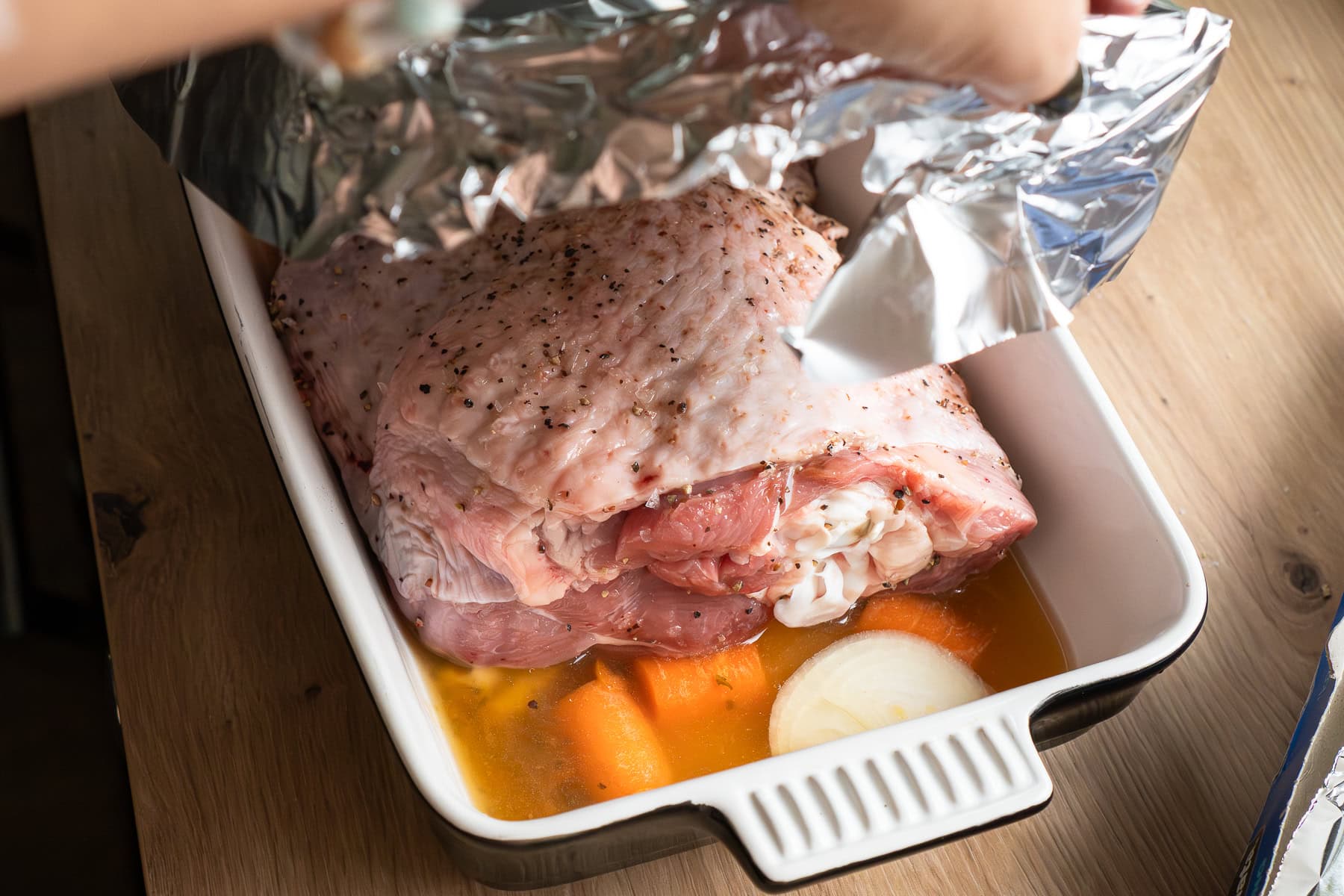 Covering the turkey thigh in a oven proof dish with foil