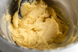 Fairy cake batter mixing in a silver mixing bowl