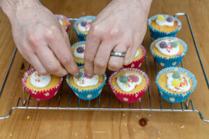 Place the sweets on top of the fairy cakes
