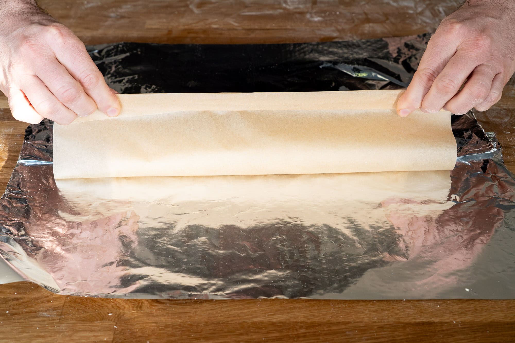 Wrapping the parchment paper round the roly poly