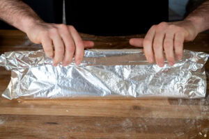 Wrapping the foil round the jam roly poly