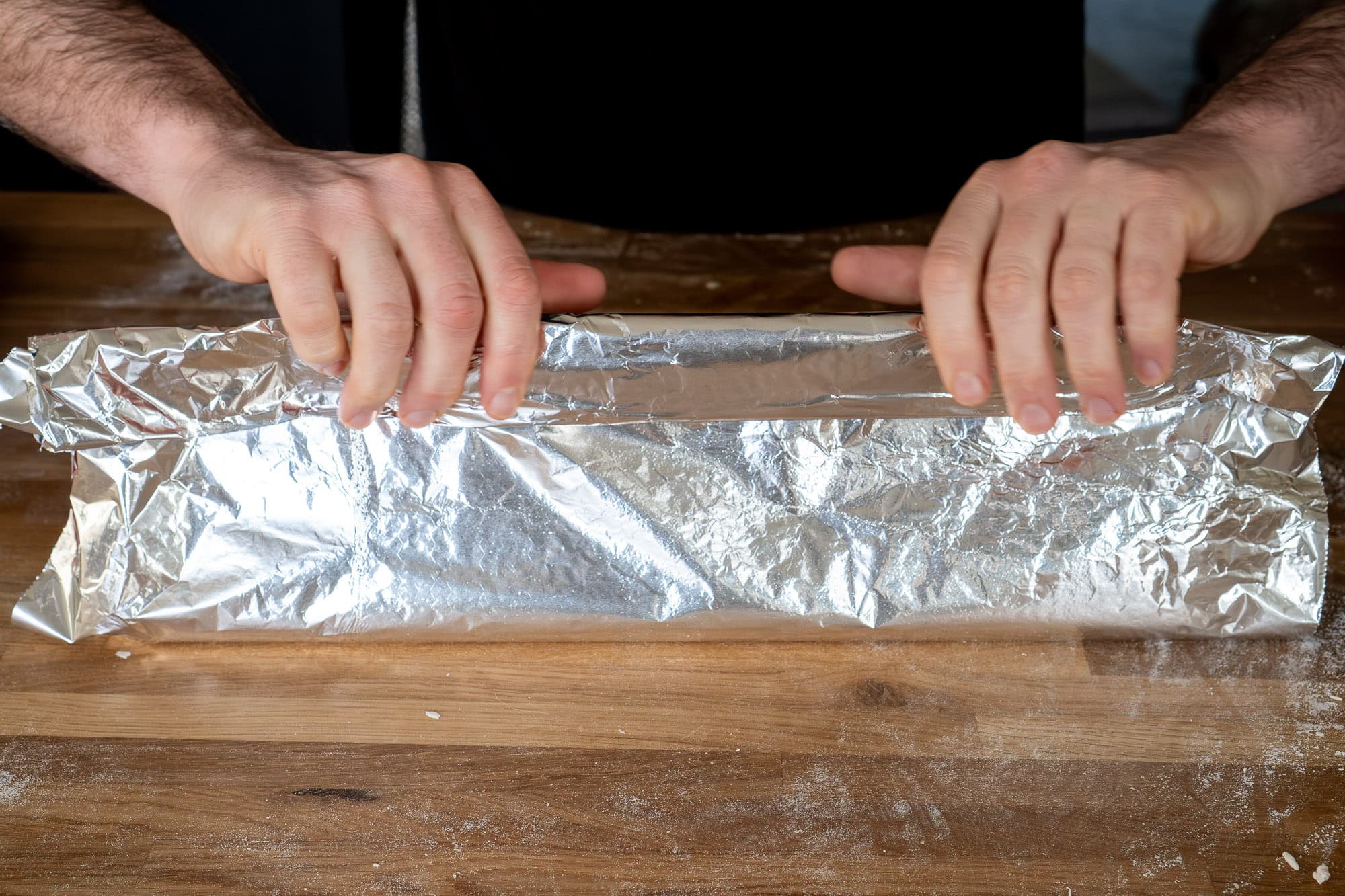 Wrapping the foil round the jam roly poly