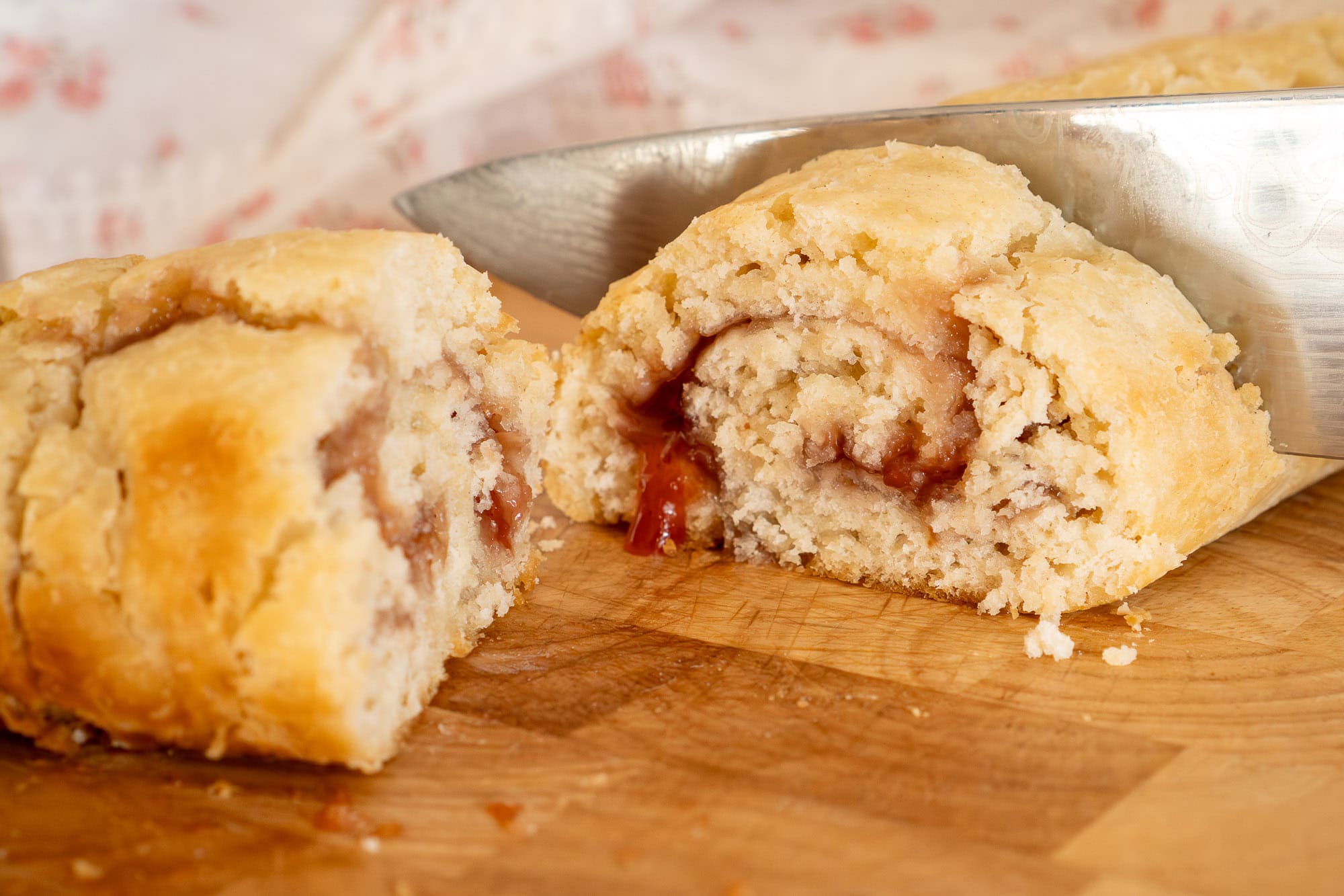A slice of jam roly poly with jam oozing out