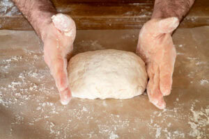 Suet dough on a sheet of floured parchment paper formed into a rectangle