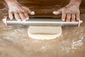 rolling out the suet dough using a rolling pin