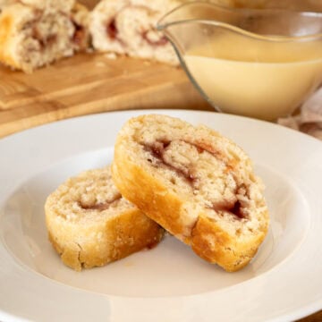 Two slices of jam roly poly in a bowl