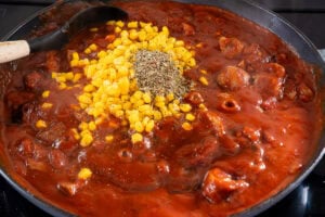 Sweetcorn and Italian mixed herbs added to the tomato sauce