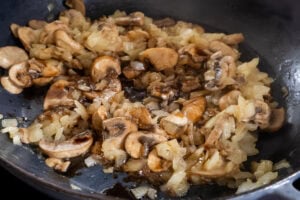 Cooked onion, mushrooms and garlic in a pan