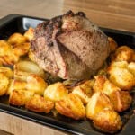 Roast beef Joint cooked with roast potatoes before the beef is removed to rest.