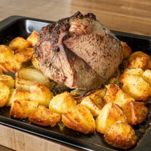 Roast beef Joint cooked with roast potatoes before the beef is removed to rest.