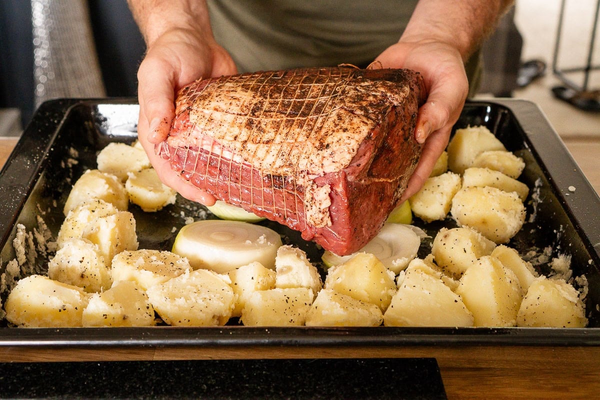 Placing Beef Joint on top of onions and cooking on same tray as the potatoes