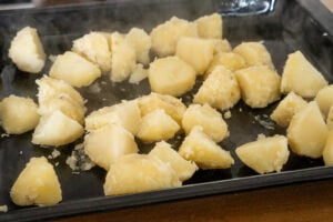 Par boiled potatoes on tray