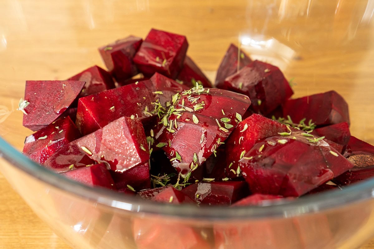 Cubes of beetroot with herbs in a glass bowl.